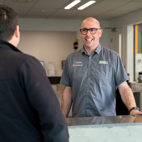 Employee from Performance Diesels greeting a customer