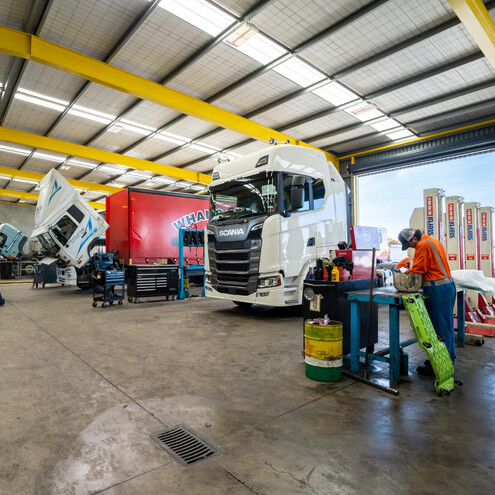 Workshop of heavy truck and trailers, multiple trucks in the workshop