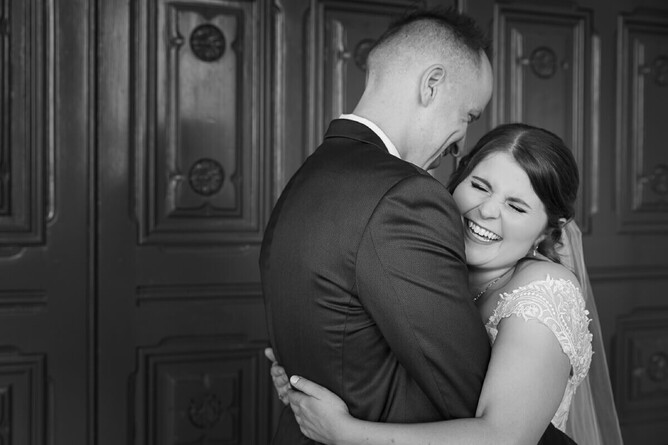 photography of couple of wedding day in black and white outside wellington parlimentry doors