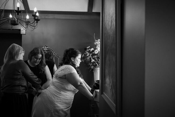 photograph of a bride getting ready on her wedding day in black and white documentary