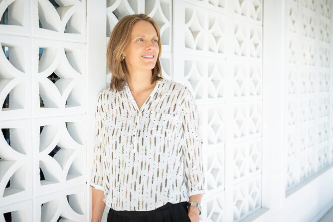 business braning photograph of woman leaning on a wall in wellington