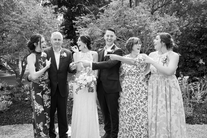 black and white wedding photograph of wedding couple and family having fun mel waite photography
