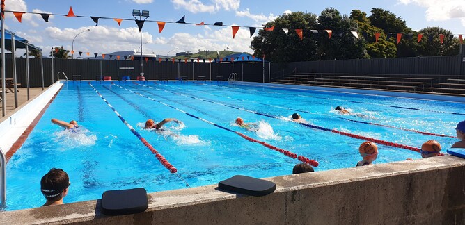 Children swim laps in swimming pool