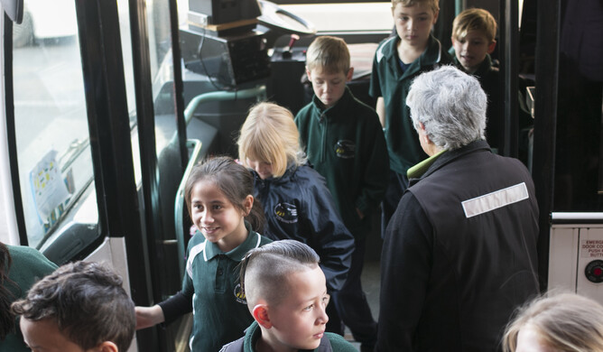 Children step off bus to visit Tauranga Art Gallery