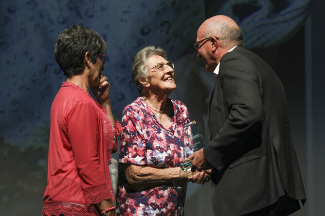 Lou Rigg receives her award from TECT Chairperson Bill Holland