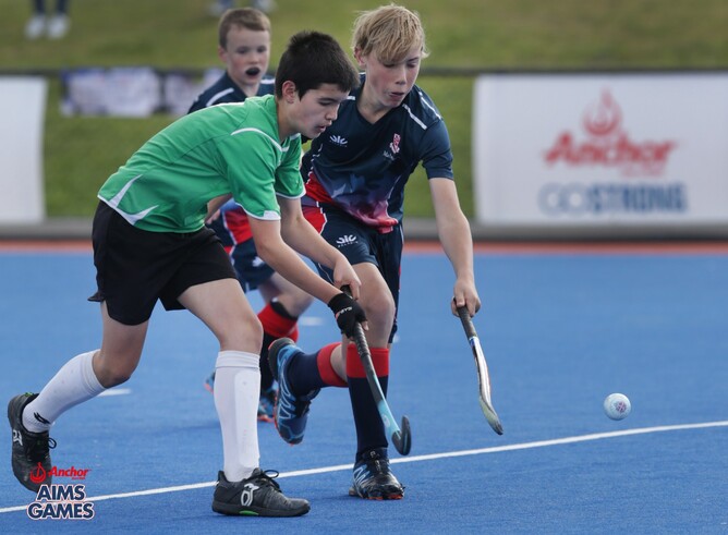Three boys playing hockey