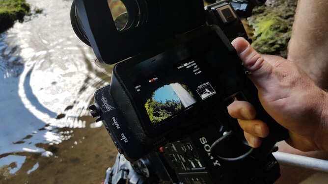 Looking through viewfinder of camera