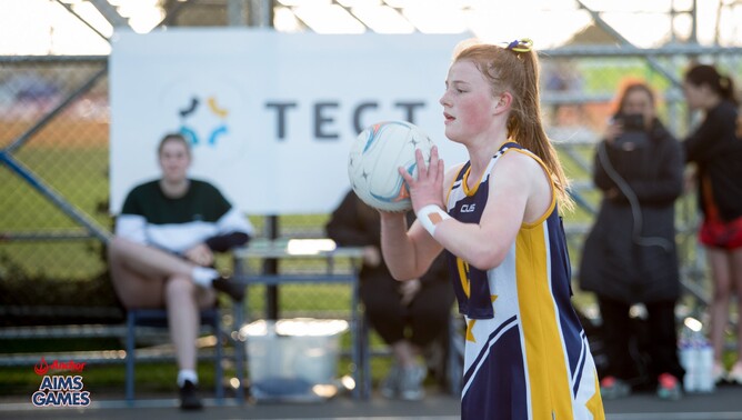Girl prepares to pass netball
