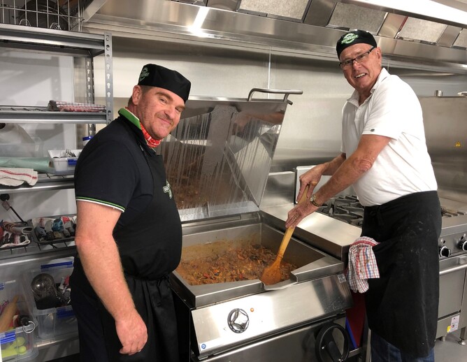 Good Neighbour chefs cook meal in kitchen