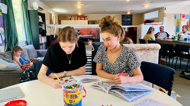 Sophia Mudgway and Shania Whale, mentor, colour in books