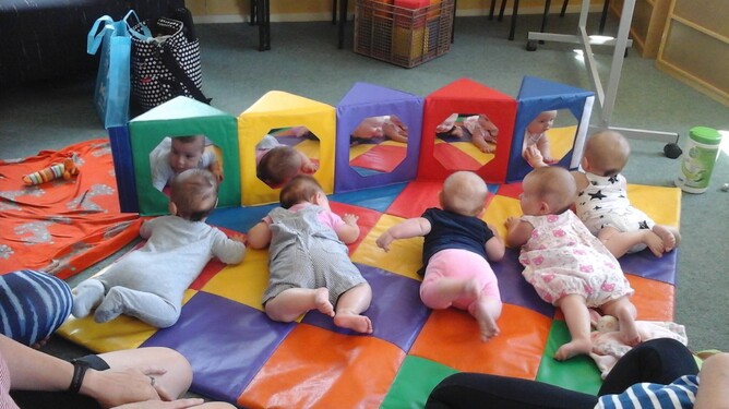 Babies lying on playmat