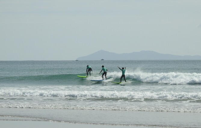 Three Live for More participants enjoying surfing
