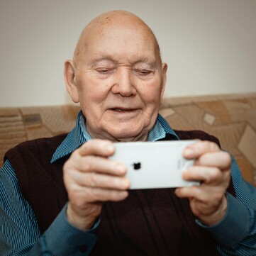 Elderly man uses iPhone