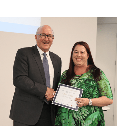 Scholarship recipient Anita Lewis shakes hand with TECT Chairperson Bill Holland