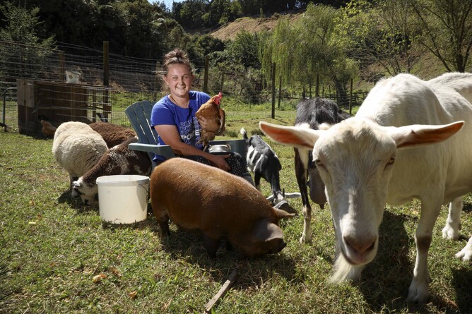 Rowan Elliott poses with animals cared for by RRR - Rescue, Revive, Rehome