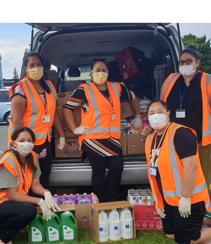 Five Pacific Island Community Trust team members pose with groceries to be delivered