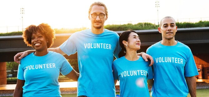Four people with blue Volunteer t-shirts on
