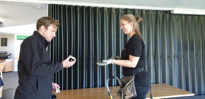 Two LiteClub staff replace lightbulbs