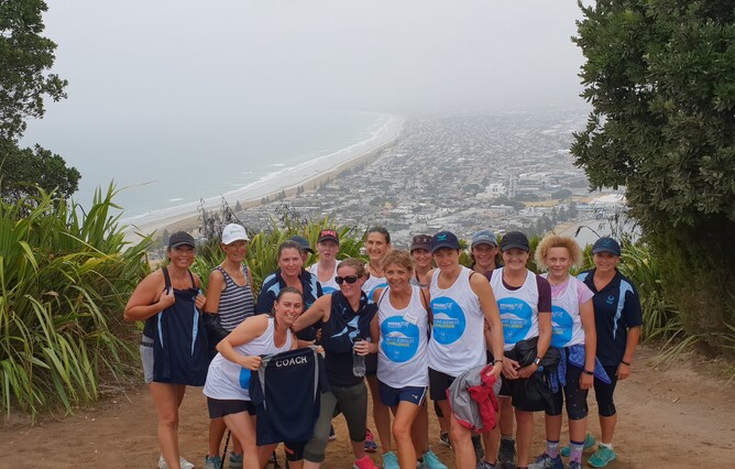 People stand at top of the Mount in their fundraising t-shirts