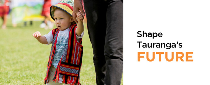 Toddler holding hand of adult while standing