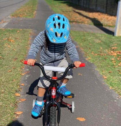 Child biking down footpath