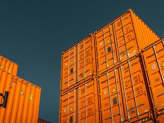 A stack of shipping containers against a blue sky