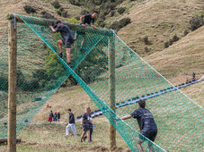OCR Blazing Hills, Cargo net, A frame, high in the air people climbing over. Obstacle