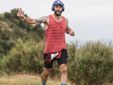 Trail runner, all smiles at blazing hills, on top of a hill with all the views . Head phones and a peace sign