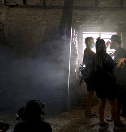 Laura working,  providing makeup on a film set.