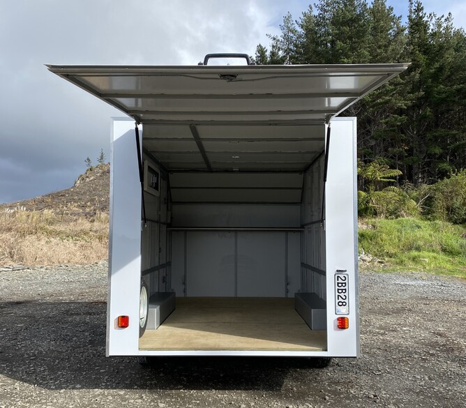 Opening rear door custom tandem axle enclosed trailer build by Alted Engineering