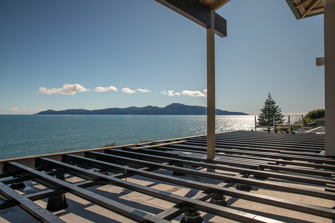 Site-specific engineered floating deck solution with no fixings to the building, Wellington region.