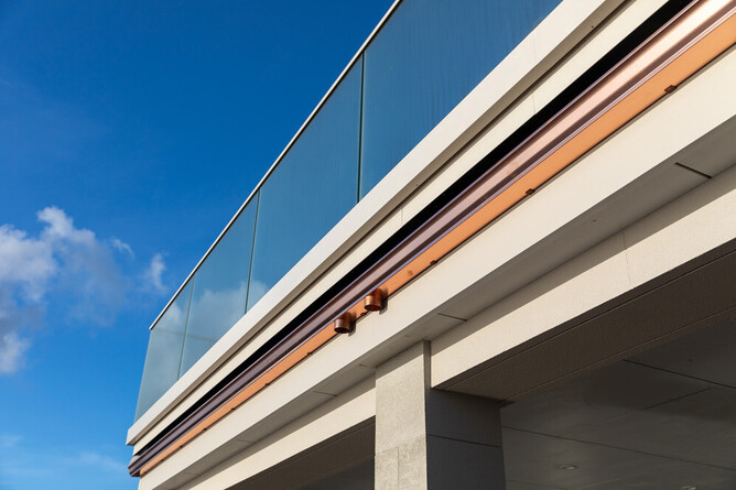 Completed floating deck with frameless glass balustrade overlooking Kapiti Coast beachfront.