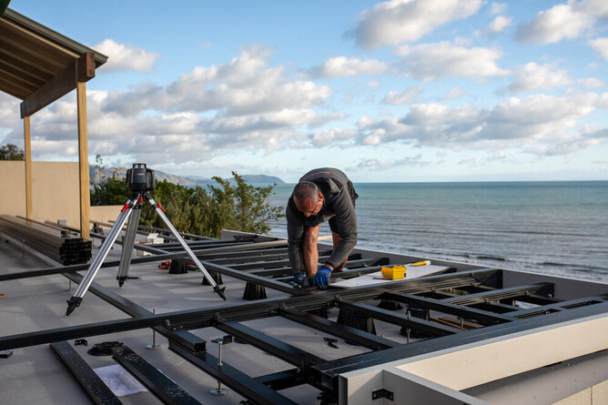 TreadTech aluminium floating deck framing installed on Kapiti Coast rooftop with ocean views.