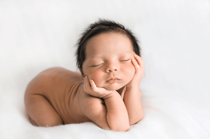peaceful newborn posing on blanket