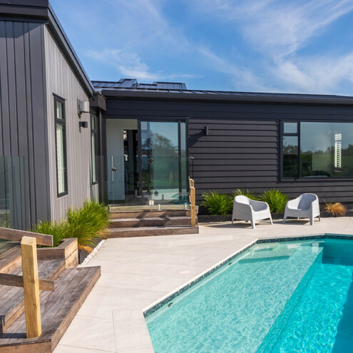 Modern cedar clad two story home with white brick garage
