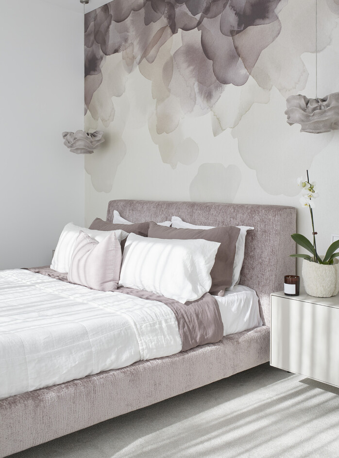Master suite bedroom with striking watercolour wallpaper and feature pendant