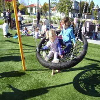 Sprouts kids on park swing