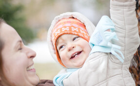Child Carer with happy baby