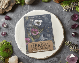 The Herbal Astrology Pocket Oracle on a moss and gem background