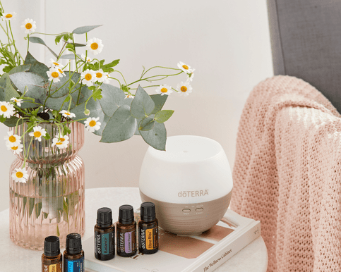 doterra diffuser doterra essential oils a vase and a book on a table