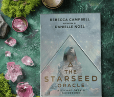 The Starseed Oracle Card Deck on a moss and gem background