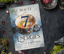 Oracle of the 7 Energies Oracle Card Deck by Colette Baron-Reid on a moss and gem background