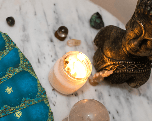 Oracle Cards on a desk with a candle and crystals