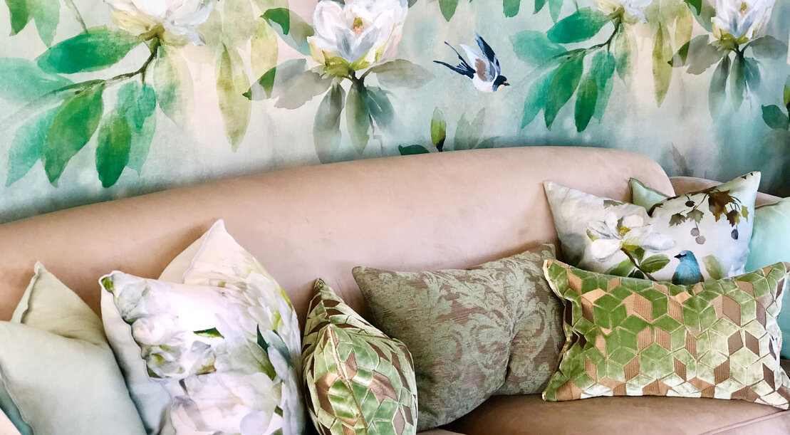 Upholstered couch with print cushions and floral wallpaper. Upholstery and interior design and styling by Julia Empson Interiors. Ohaupo. Waikato, New Zealand.
