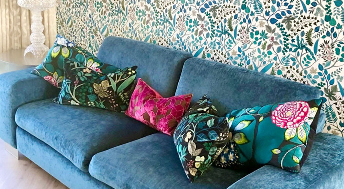 Blue couch with floral cushions and wallpaper. Upholstery and interior design and styling by Julia Empson Interiors. Ohaupo. Waikato, New Zealand.