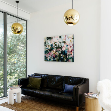 A light bathed couch to sit on at The Salon queenstown.