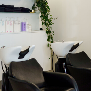 The basin area of The Salon with EVO hair products.