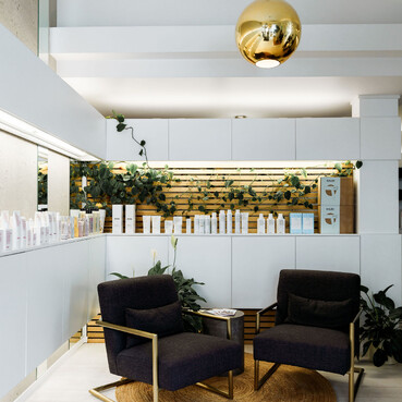 The waiting area of The Salon with relaxing arm chairs and beautiful decor.