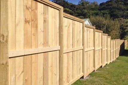 a single sided wooden fence with a climb point on the lesser side