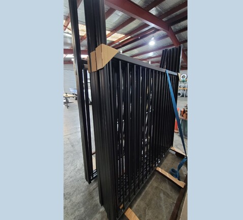 photo of pre-assembled panels, on a rack, ready for delivery to Auckland